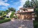 Two-story house with a brown garage door and landscaped yard at 325 Sonoma Valley Cir, Orlando, FL 32835