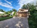 Two-story house with a brown garage door and landscaped yard at 325 Sonoma Valley Cir, Orlando, FL 32835