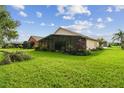 Spacious backyard with covered patio and lush green lawn at 540 Genoa Dr, Poinciana, FL 34759