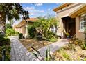 Attractive front yard with landscaping, fountain, and paved pathway leading to the entrance at 561 Sienna Dr, Poinciana, FL 34759