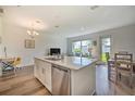 Modern kitchen with island, stainless steel appliances, and white cabinets at 709 Benoi Dr, Davenport, FL 33896