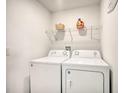 Laundry room with washer and dryer, shelving for storage at 709 Benoi Dr, Davenport, FL 33896