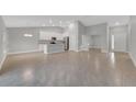 Open living area with tile floors and kitchen access at 792 Del Prado Dr, Kissimmee, FL 34758
