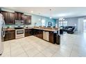 Open kitchen with stainless steel appliances and granite countertops at 9158 Wedge Dr, Davenport, FL 33896