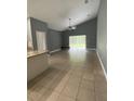 Spacious living room with tile flooring and sliding glass doors to backyard at 1021 Hacienda Cir, Kissimmee, FL 34741