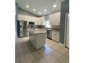 Modern kitchen featuring white cabinets, granite countertops, and stainless steel appliances at 1021 Hacienda Cir, Kissimmee, FL 34741
