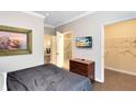 Bedroom with queen bed, ensuite bathroom, and walk-in closet at 1301 Tuscan Ter # 9106, Davenport, FL 33896
