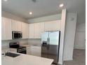 Modern kitchen with stainless steel appliances and island at 2720 Pierr St, Davenport, FL 33837