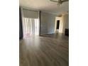 Living room with hardwood floors and sliding glass doors at 3077 Brenton Manor Loop, Winter Haven, FL 33881