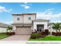 Two-story house with a two-car garage and brick driveway at 5075 Twin Lakes Blvd, St Cloud, FL 34772