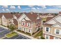 Aerial view of charming townhouses with inviting landscaping and ample parking at 7585 Sunny Dreams Ln, Kissimmee, FL 34747