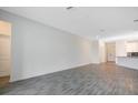 Large living room with gray tile floors and an open concept kitchen at 2971 Camden Way, Davenport, FL 33837