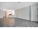 Spacious living room with gray tile floors and a modern kitchen at 2971 Camden Way, Davenport, FL 33837