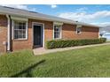 Brick home's side view, showcasing a walkway and lawn at 3401 Home Town Ln, St Cloud, FL 34769