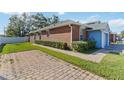 Side view of a light blue and brick home with a garage at 3401 Home Town Ln, St Cloud, FL 34769