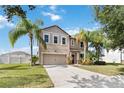 Two-story house with a two-car garage and lush lawn at 3804 Marietta Way, St Cloud, FL 34772