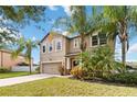 Two-story house with a two-car garage and palm trees at 3804 Marietta Way, St Cloud, FL 34772