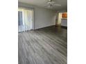 Living room with grey wood-look flooring and sliding door to patio at 1025 S Hiawassee Rd # 2216, Orlando, FL 32835