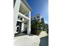 Modern apartment building with a walkway and landscaping at 1230 Southstation Place # 403, Orlando, FL 32809