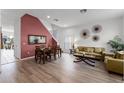 Bright living room with hardwood floors, a large sectional sofa, and access to a patio at 131 Cadiz Loop, Davenport, FL 33837