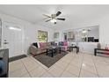 Bright living room with sectional sofa, coffee table, and tile floors at 136 Alhambra Ave, Altamonte Springs, FL 32714