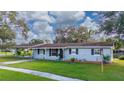 Newly painted light blue ranch home with carport and well-maintained lawn at 136 Alhambra Ave, Altamonte Springs, FL 32714
