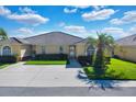 Front view of a charming villa with a landscaped yard at 2216 Mystic Ring Loop, Poinciana, FL 34759