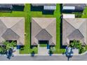Three villas viewed from above with green lawns at 2216 Mystic Ring Loop, Poinciana, FL 34759