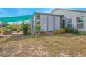 Private backyard patio with covered seating area and lush landscaping at 2649 Sunset Cir, Lake Wales, FL 33898