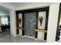 Contemporary entryway showcasing a circular-patterned wall accent and sleek design at 2737 Nottel Dr, Saint Cloud, FL 34772