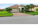 One-story home with a brick driveway and lush landscaping at 3878 Carrick Bend Dr, Kissimmee, FL 34746