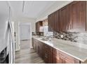 Modern kitchen with granite countertops and dark wood cabinets at 2108 Lemon St, Haines City, FL 33844