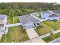 One-story home with gray siding, solar panels, and fenced backyard at 356 Citrine Loop, Kissimmee, FL 34758