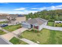 Single-story house with gray siding, solar panels, and a spacious yard at 356 Citrine Loop, Kissimmee, FL 34758