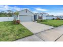 Gray house with red shutters, driveway, and grassy yard at 356 Citrine Loop, Kissimmee, FL 34758