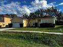 One-story house with a two-car garage and well-maintained lawn at 481 Peppermill Cir, Kissimmee, FL 34758