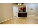 Dining area with tile floors and kitchen bar at 5773 Gatlin Ave # 627, Orlando, FL 32822