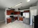 Kitchen features stainless steel appliances and ample wood cabinets at 824 San Pedro Ct, Kissimmee, FL 34758