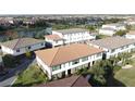 Community view showing townhomes near a lake at 10090 Sunnifa Aly, Orlando, FL 32832