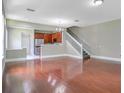 Spacious living room with hardwood floors and view of kitchen at 1060 Rock Harbor Ave, Orlando, FL 32828