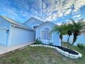 Curb appeal! Newly painted light blue house with stone landscaping at 2907 Delcrest Dr, Orlando, FL 32817