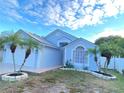 Newly painted light blue house with palm trees and well-manicured lawn at 2907 Delcrest Dr, Orlando, FL 32817