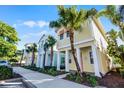 Row of colorful houses, including a yellow house with orange accents and palm trees at 3075 Key Lime Loop, Kissimmee, FL 34747