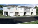 New townhouses with various exterior colors and two-car garages at 437 Madison Dr, Davenport, FL 33837