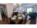 Bright dining room with a wooden table and seating for six at 468 Andalusia Loop, Davenport, FL 33837