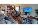 Spacious living room featuring comfortable seating and a large TV at 468 Andalusia Loop, Davenport, FL 33837