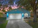 Blue house with a two-car garage, nighttime view at 7722 Water Oak Ct, Kissimmee, FL 34747