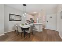 Dining area with marble-top table, modern light fixture, and view of the kitchen at 8404 Crystal Cove Loop, Kissimmee, FL 34747