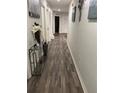 Long hallway with wood-look flooring and access to other rooms at 106 Orchid Ct, Kissimmee, FL 34759