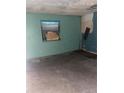 Empty bedroom with light teal walls and wood floors at 1604 Royal Palm Dr, Edgewater, FL 32132